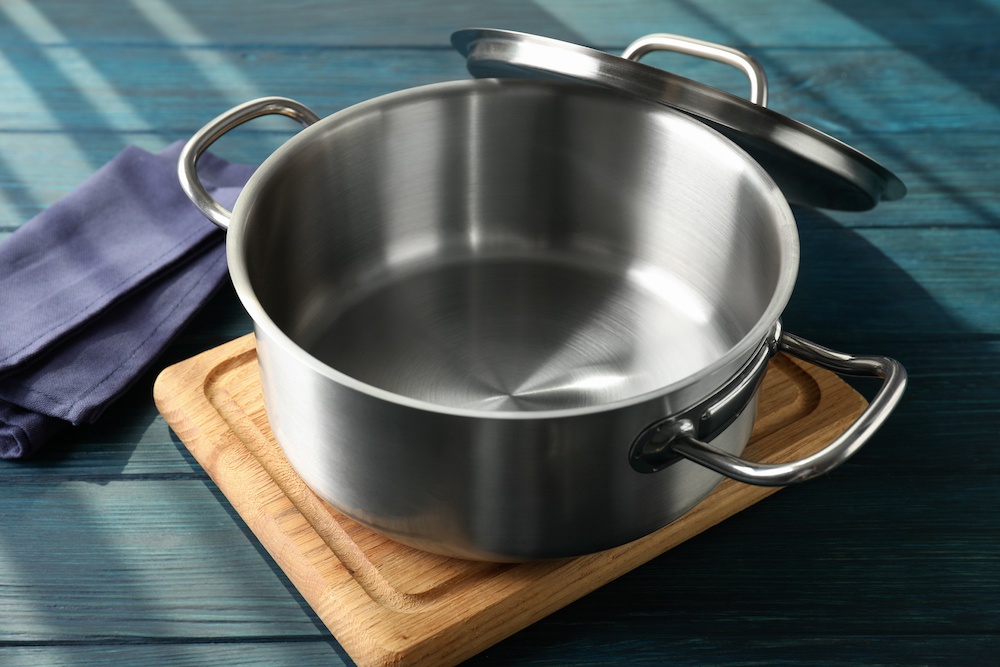 Stalowy garnek na desce do krojenia